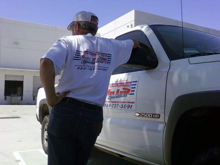 Daniel Ruppel of Classic Tile & Stone Specialists in branded shirt next to the company truck