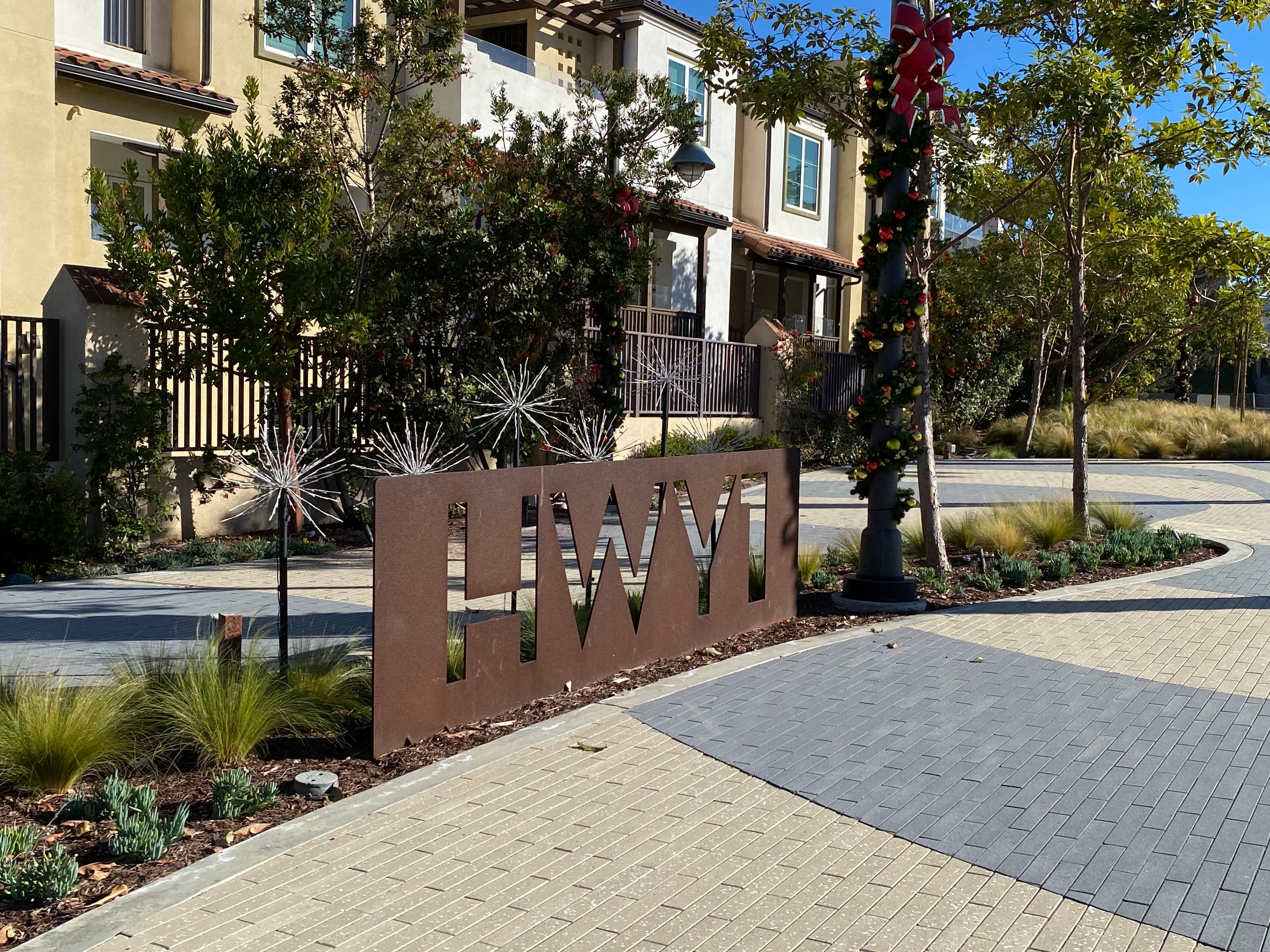 Dana Point public streetscape with paver walkway and cor-ten steel highway signage near a CTS commercial install