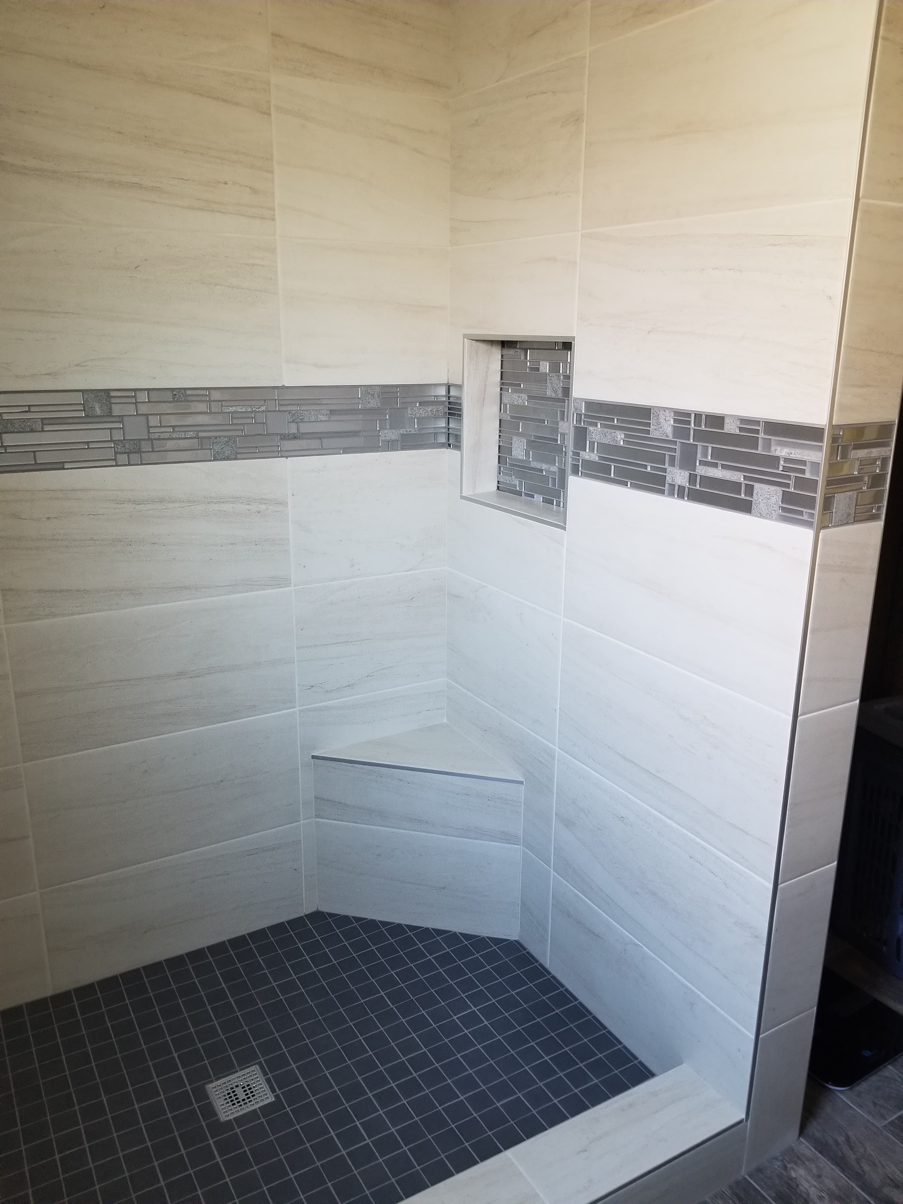 Spa-inspired shower with cream subway walls and gray mosaic accent in Menifee, CA