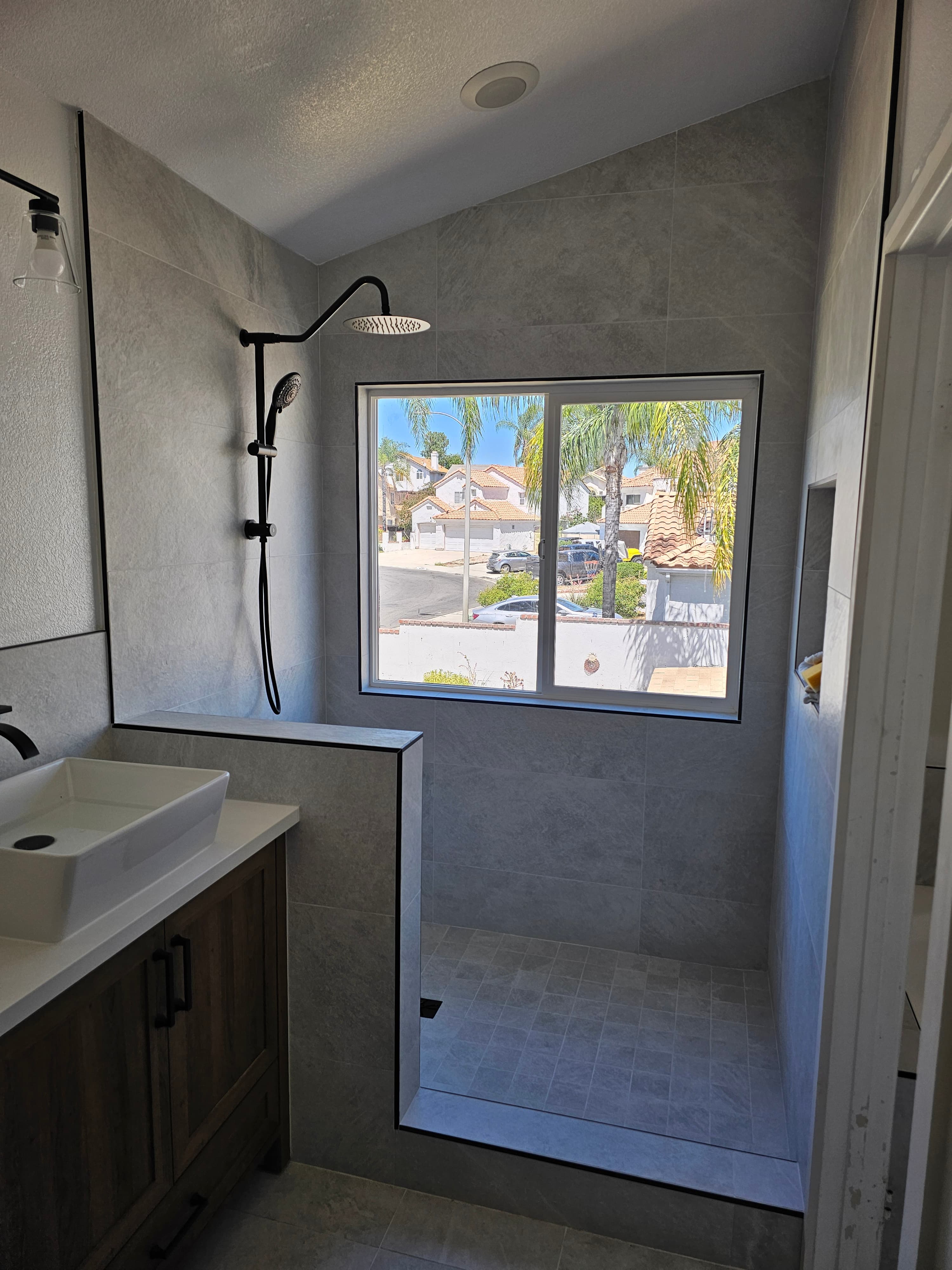Luxe shower enclosure with geometric gray cement tile flooring, Murrieta, CA